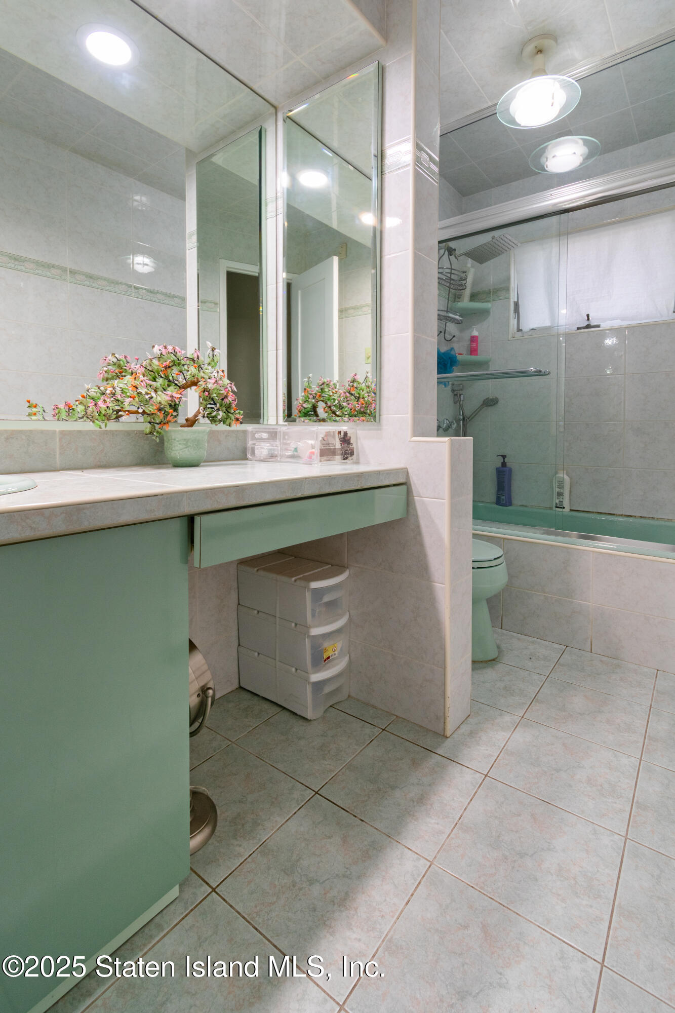 16 Ismay Street Staten Island, NY 10314 - Photo 28 of 39 a bathroom with a sink and mirror