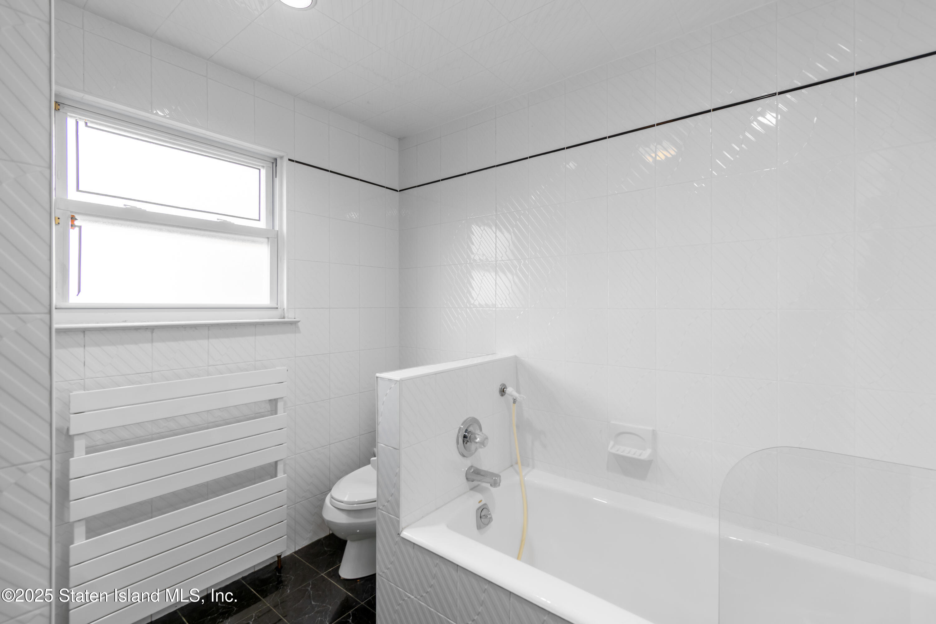 16 Ismay Street Staten Island, NY 10314 - Photo 30 of 39 a bathroom with a bathtub and a shower