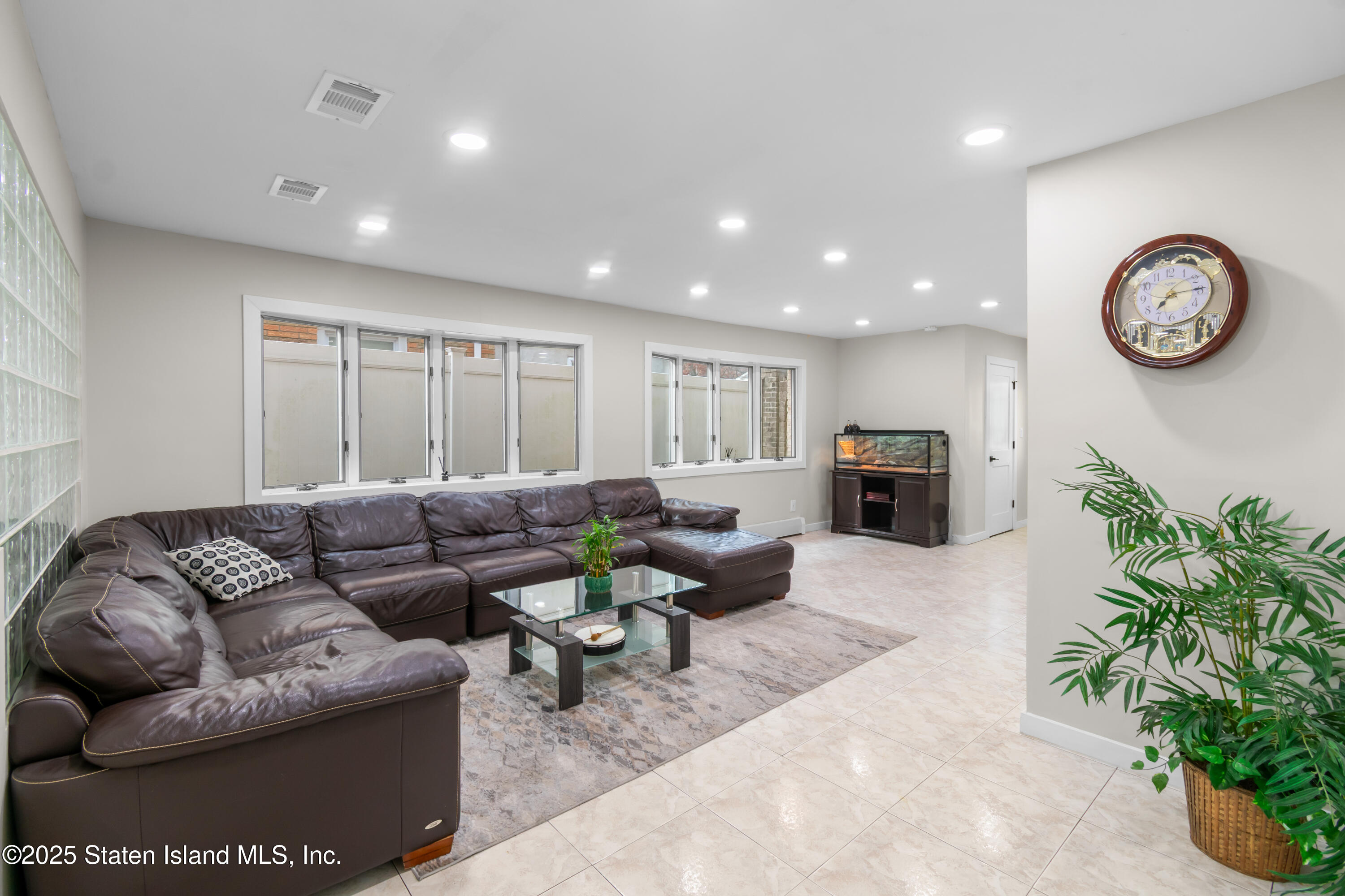 16 Ismay Street Staten Island, NY 10314 - Photo 5 of 39 a living room with furniture a clock and a potted plant