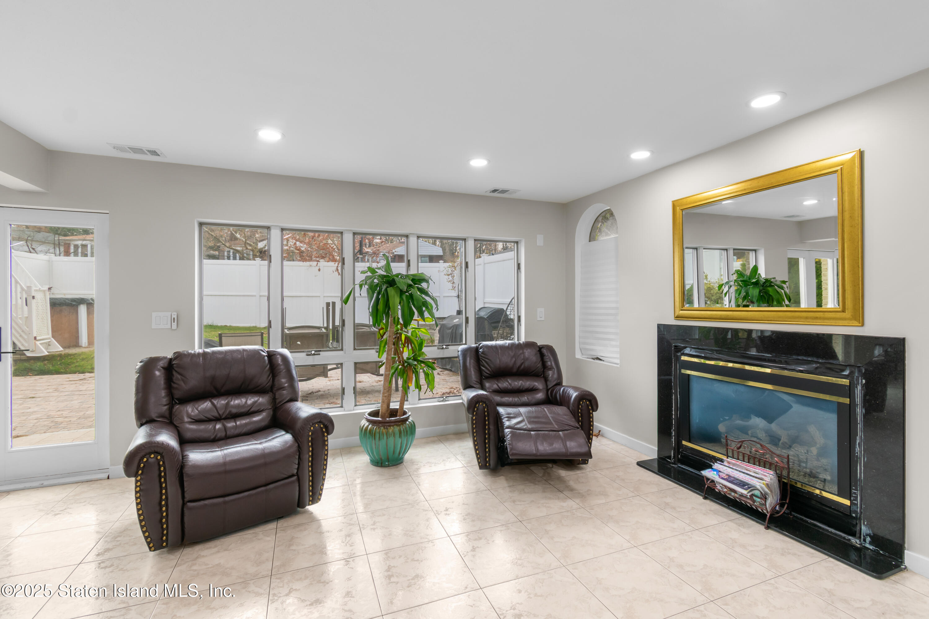 16 Ismay Street Staten Island, NY 10314 - Photo 7 of 39 a living room with furniture and a fireplace