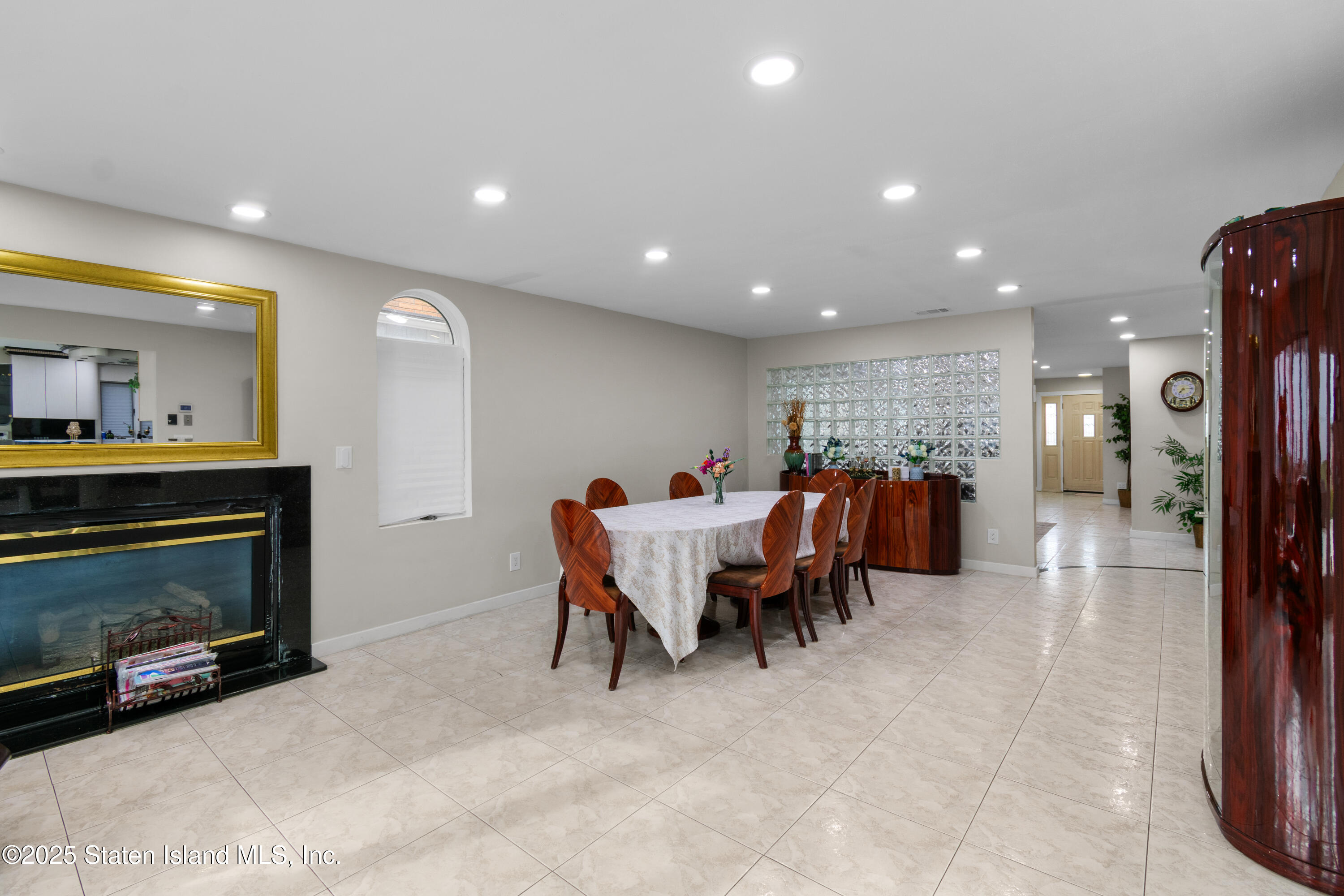 16 Ismay Street Staten Island, NY 10314 - Photo 9 of 39 a living room with furniture a fireplace and a flat screen tv