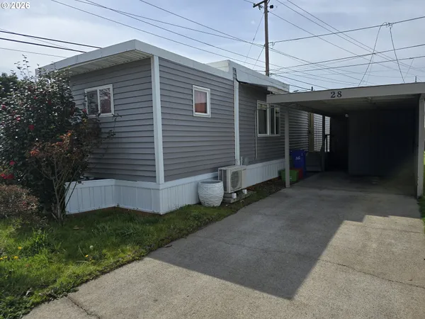 a view of a house with a small yard and wooden fence