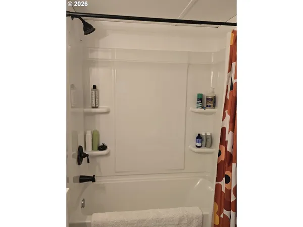 a bed room with a bed and a chair