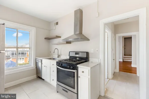 a kitchen with stainless steel appliances granite countertop a stove and a sink