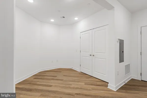 a view of a room with wooden floor