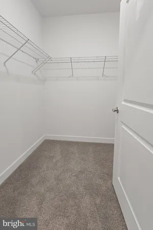 a bathroom with a granite countertop sink mirror vanity and toilet