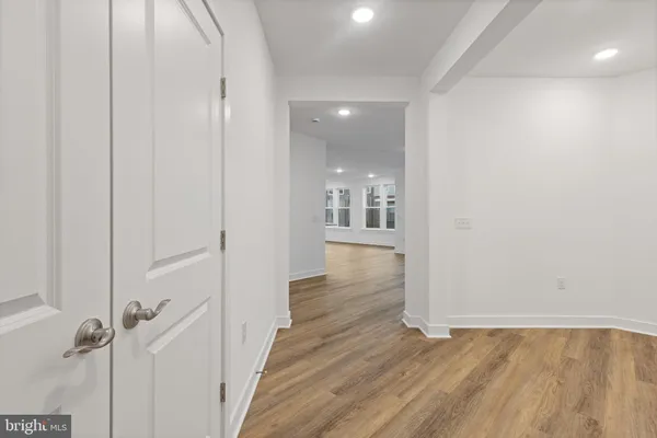 a view of a hallway with wooden floor