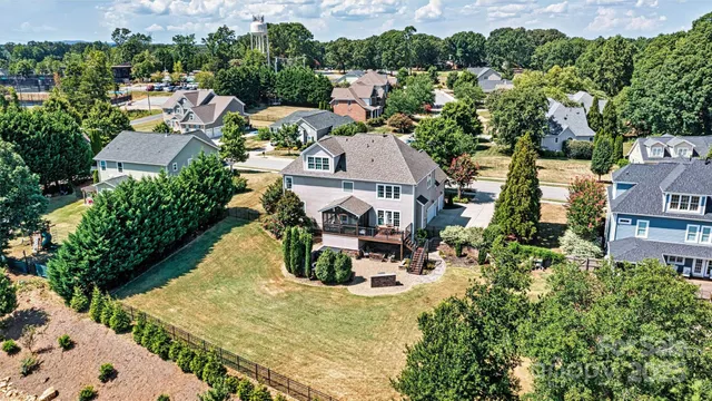 an aerial view of a house with a garden and lake view