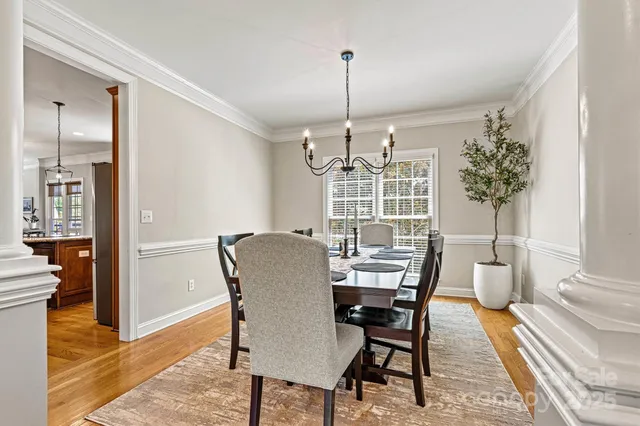 a spacious bedroom with a bed and a chandelier