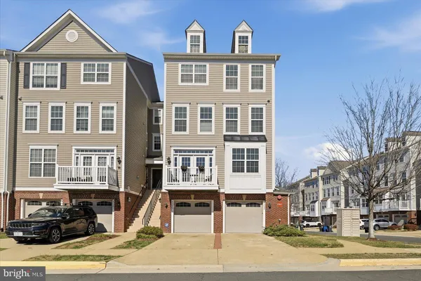a front view of a residential apartment building with a yard