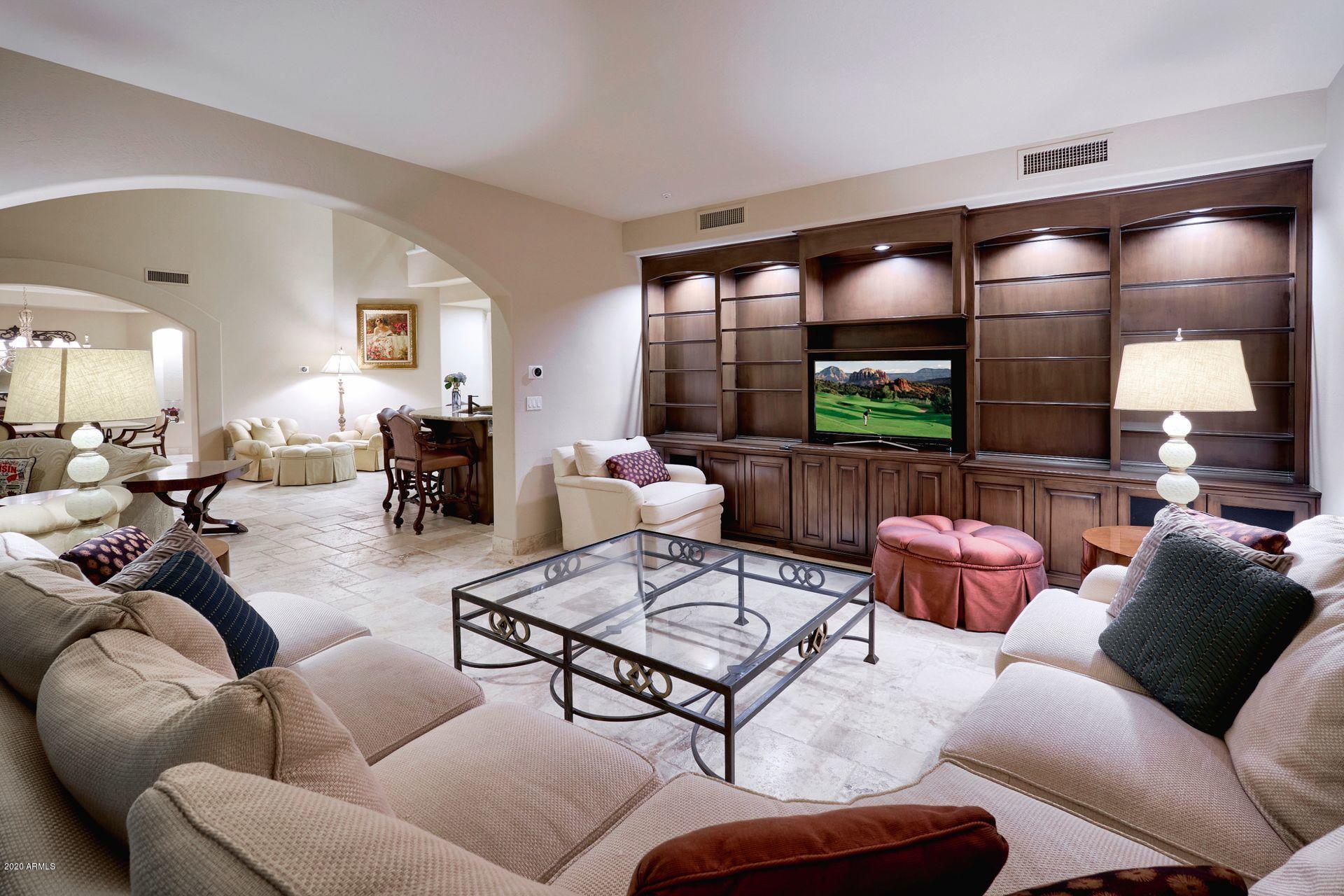 7323 East Gainey Ranch Road, Unit 4 Scottsdale, AZ 85258 - Photo 14 of 56 a living room with furniture and a large mirror
