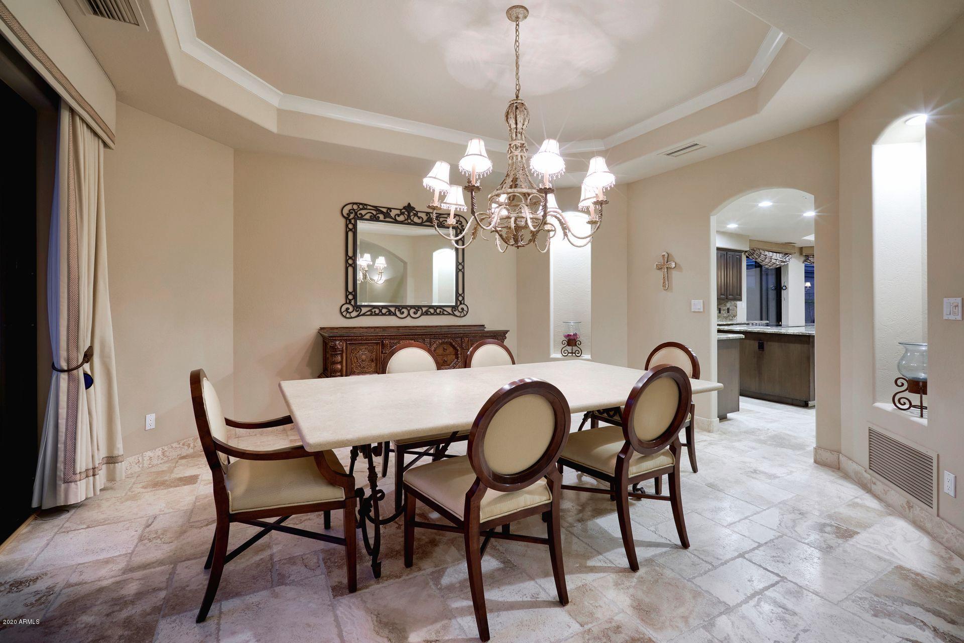 7323 East Gainey Ranch Road, Unit 4 Scottsdale, AZ 85258 - Photo 16 of 56 a view of a dining room with furniture and chandelier