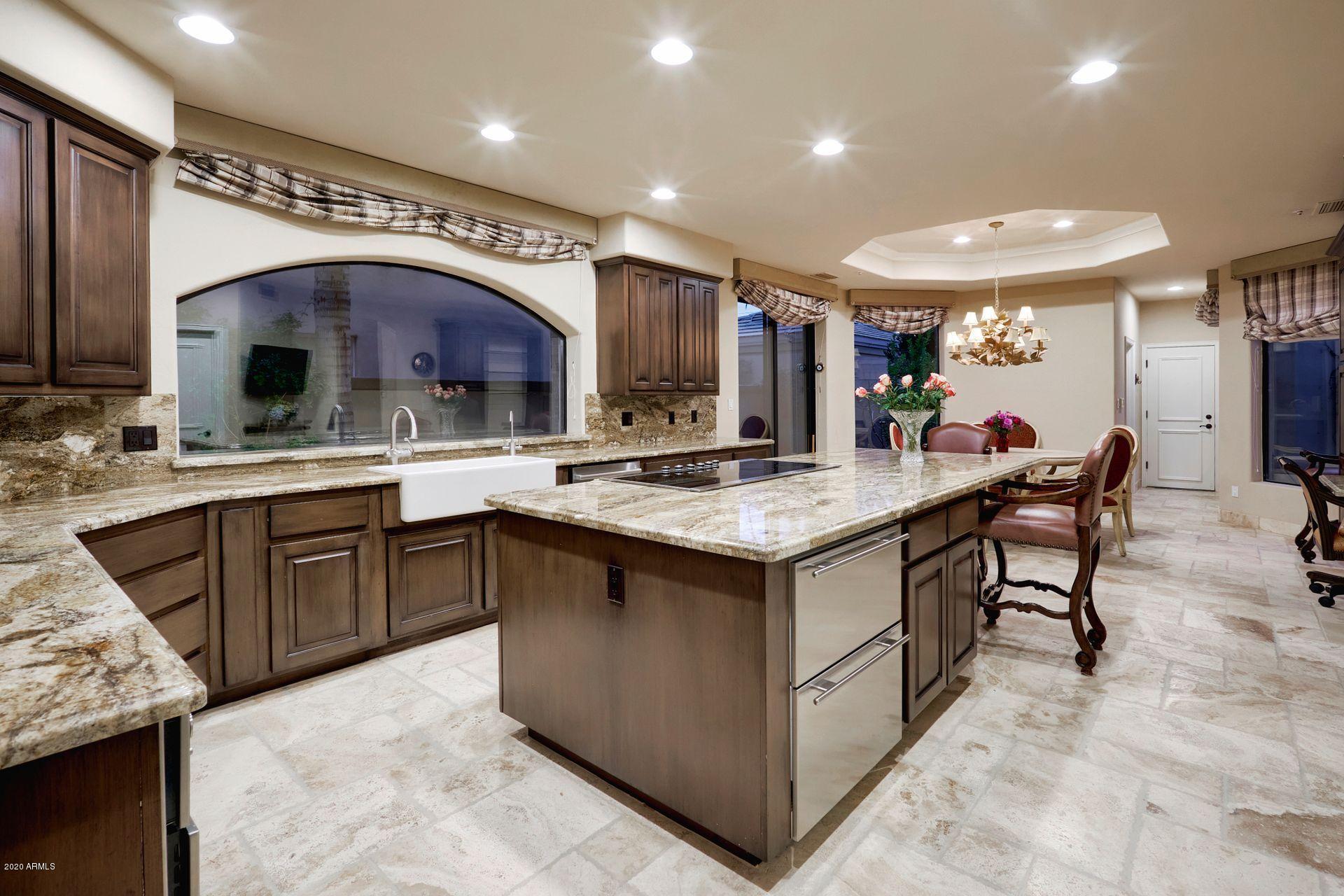7323 East Gainey Ranch Road, Unit 4 Scottsdale, AZ 85258 - Photo 17 of 56 a kitchen with a sink stove and cabinets