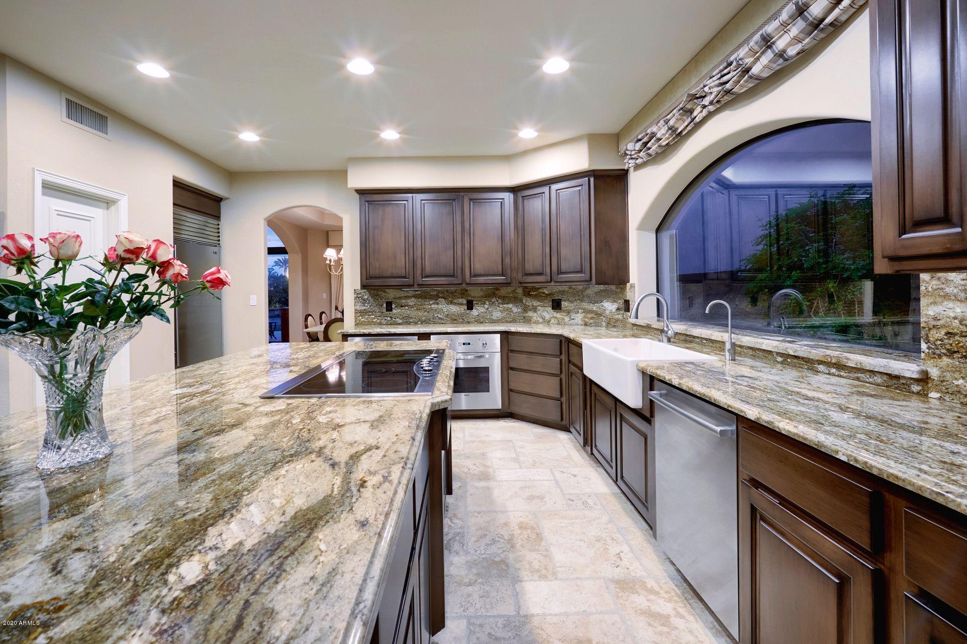 7323 East Gainey Ranch Road, Unit 4 Scottsdale, AZ 85258 - Photo 20 of 56 a large kitchen with stainless steel appliances granite countertop a large sink