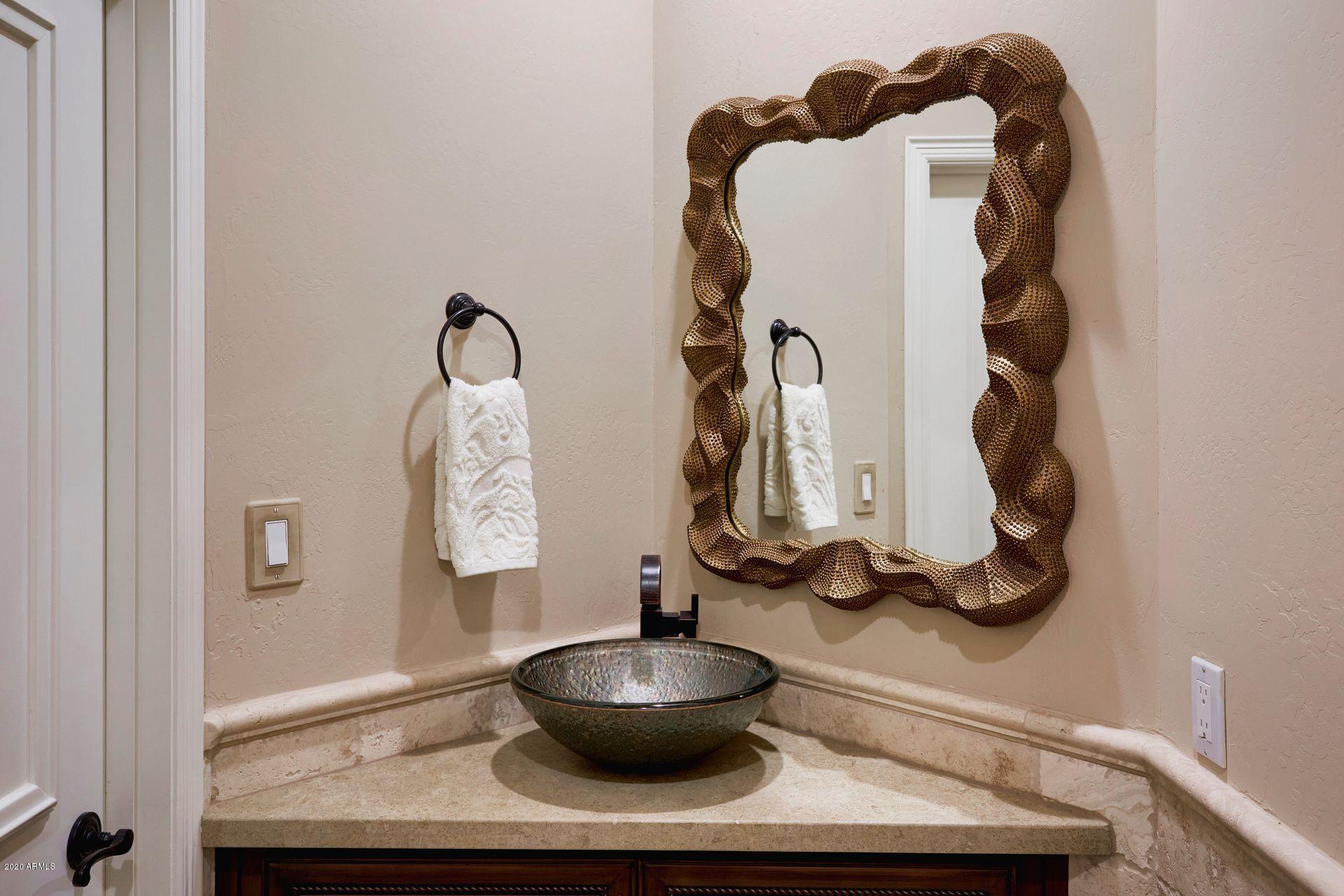 7323 East Gainey Ranch Road, Unit 4 Scottsdale, AZ 85258 - Photo 25 of 56 a bathroom with a sink and a mirror