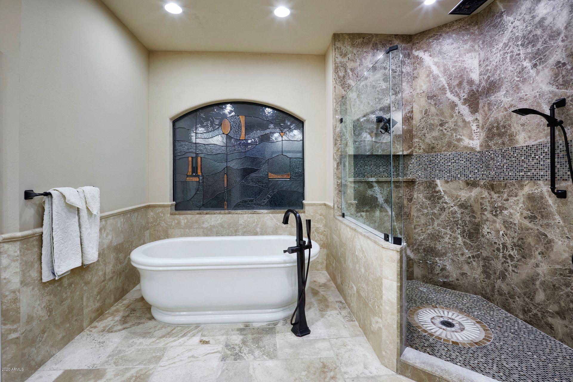 7323 East Gainey Ranch Road, Unit 4 Scottsdale, AZ 85258 - Photo 33 of 56 a bathroom with a bathtub and a shower
