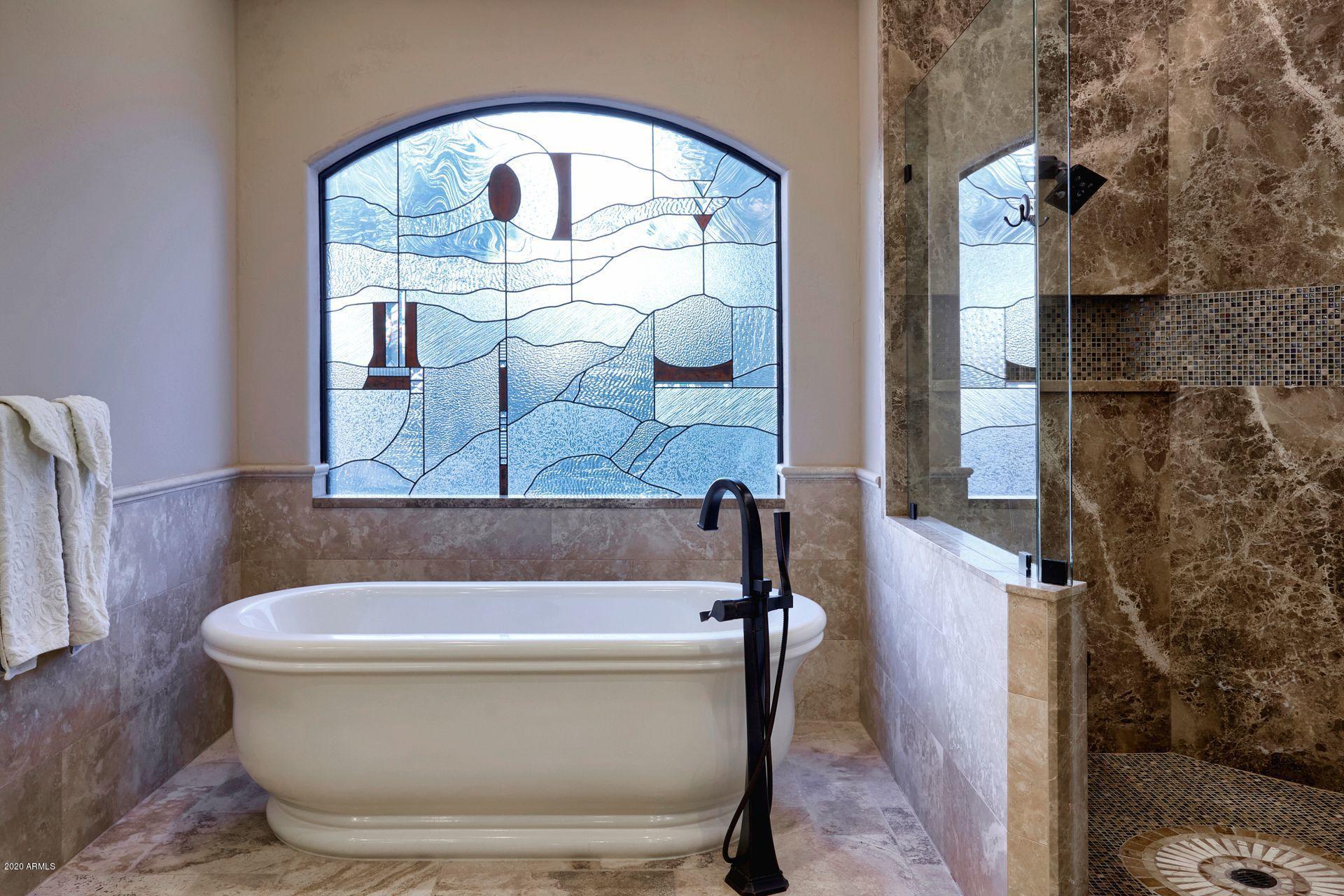 7323 East Gainey Ranch Road, Unit 4 Scottsdale, AZ 85258 - Photo 34 of 56 a bathroom with a bathtub and a shower