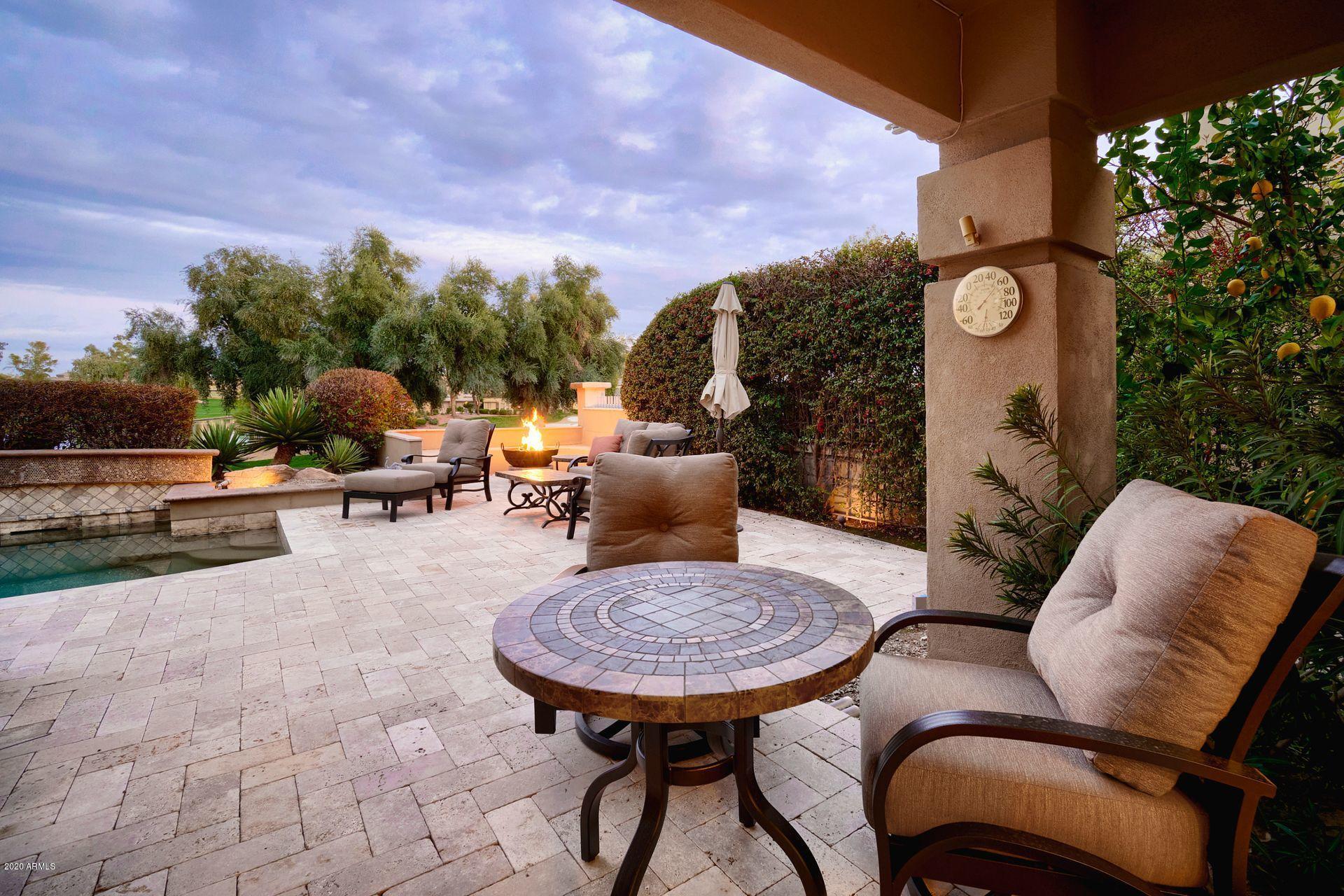 7323 East Gainey Ranch Road, Unit 4 Scottsdale, AZ 85258 - Photo 39 of 56 a view of a patio with table and chairs with a swimming pool