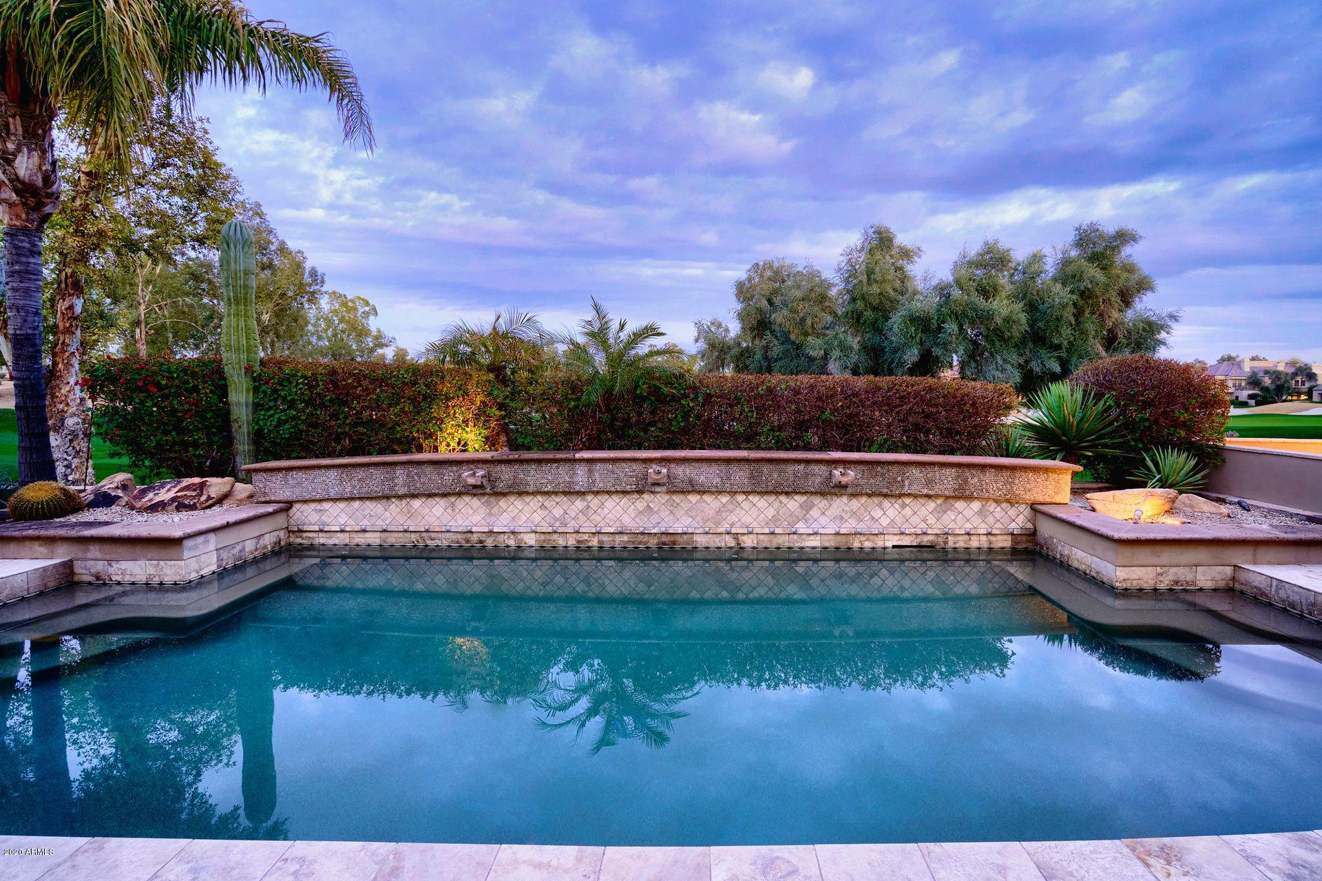 7323 East Gainey Ranch Road, Unit 4 Scottsdale, AZ 85258 - Photo 45 of 56 a view of a swimming pool with a yard