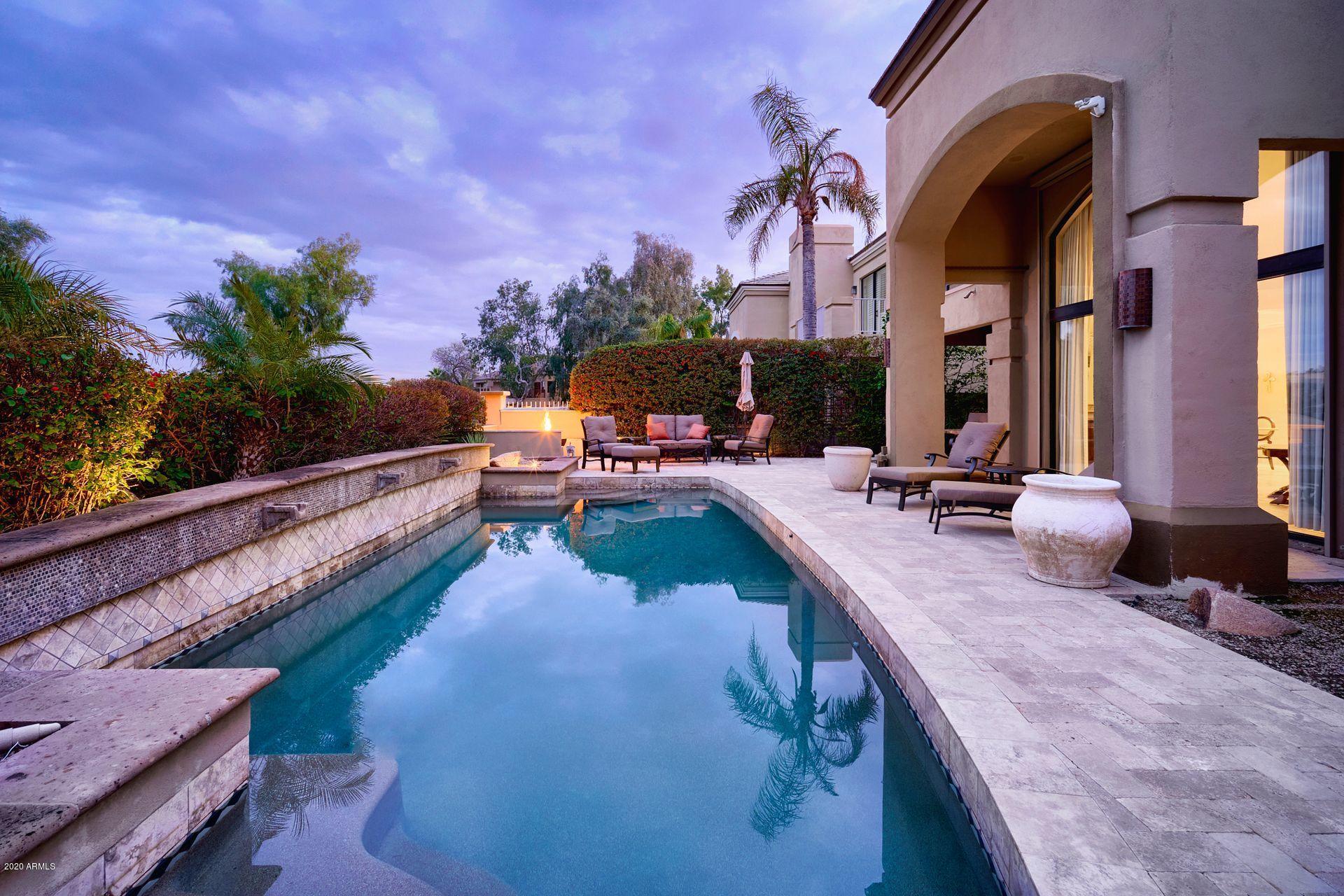 7323 East Gainey Ranch Road, Unit 4 Scottsdale, AZ 85258 - Photo 48 of 56 a view of a swimming pool with an outdoor seating