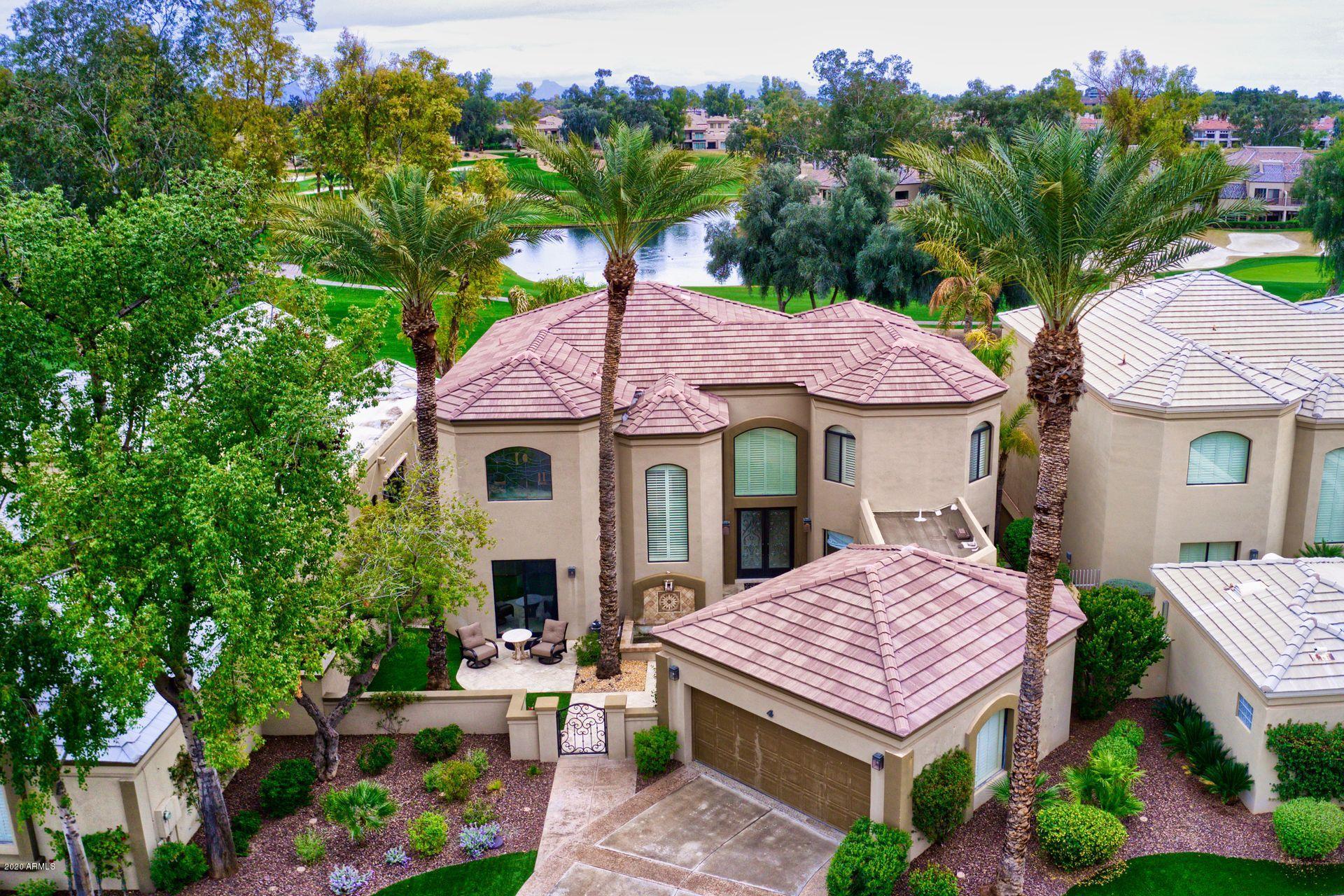 7323 East Gainey Ranch Road, Unit 4 Scottsdale, AZ 85258 - Photo 52 of 56 a view of a house with a porch and a table and chairs