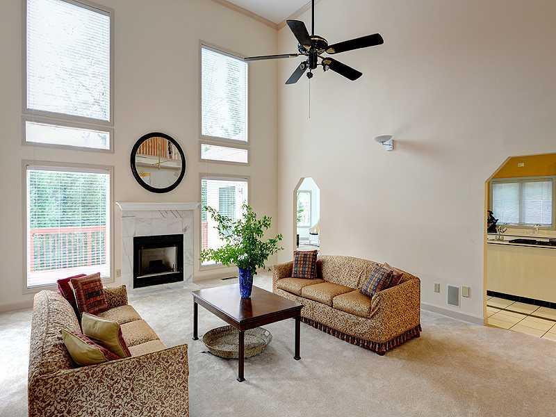 4090 Flintlock Road Northwest Atlanta, GA 30327 - Photo 1 of 1 a living room with furniture a fireplace and a large window