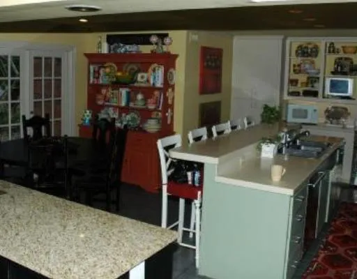 a kitchen with a sink refrigerator and cabinets