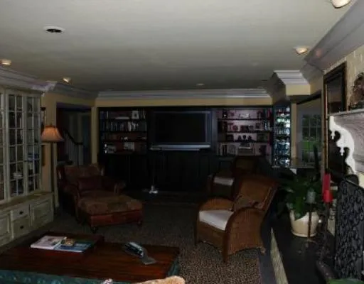 a living room with furniture a rug and a flat screen tv