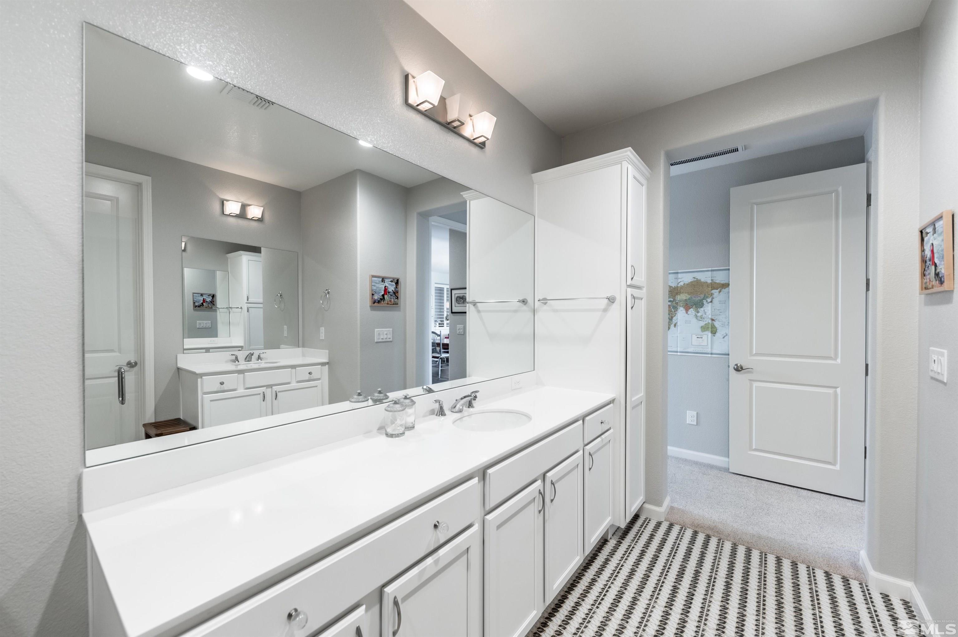 9566 Gazala Lane Reno, NV 89521 - Photo 17 of 40 a spacious bathroom with a double vanity sink and mirror