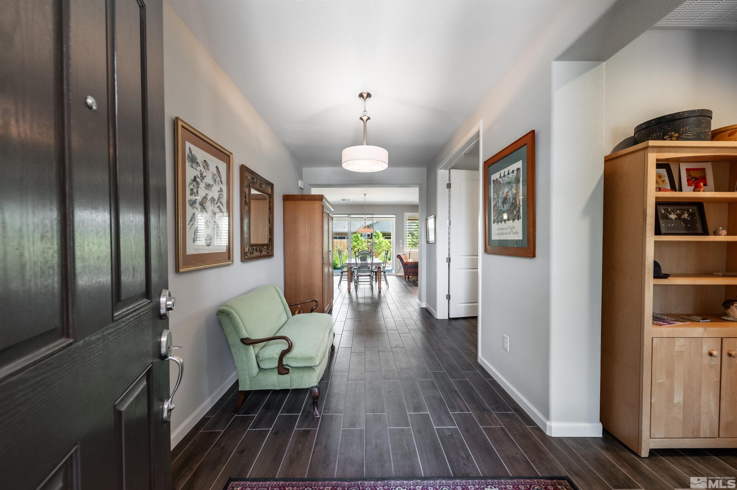 9566 Gazala Lane Reno, NV 89521 - Photo 3 of 40 a living room with furniture and a chandelier