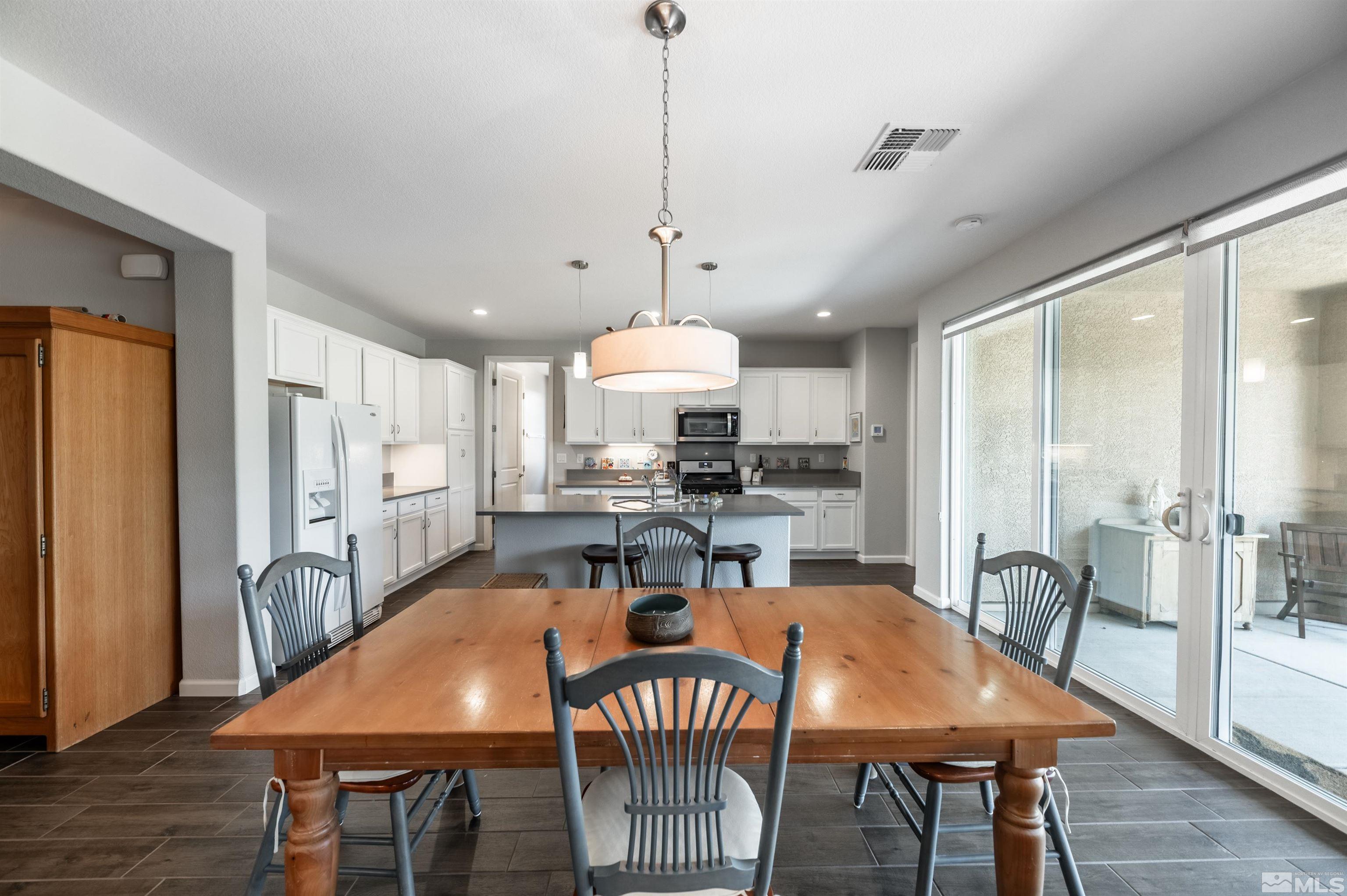 9566 Gazala Lane Reno, NV 89521 - Photo 7 of 40 a view of a a dining room with furniture window and wooden floor