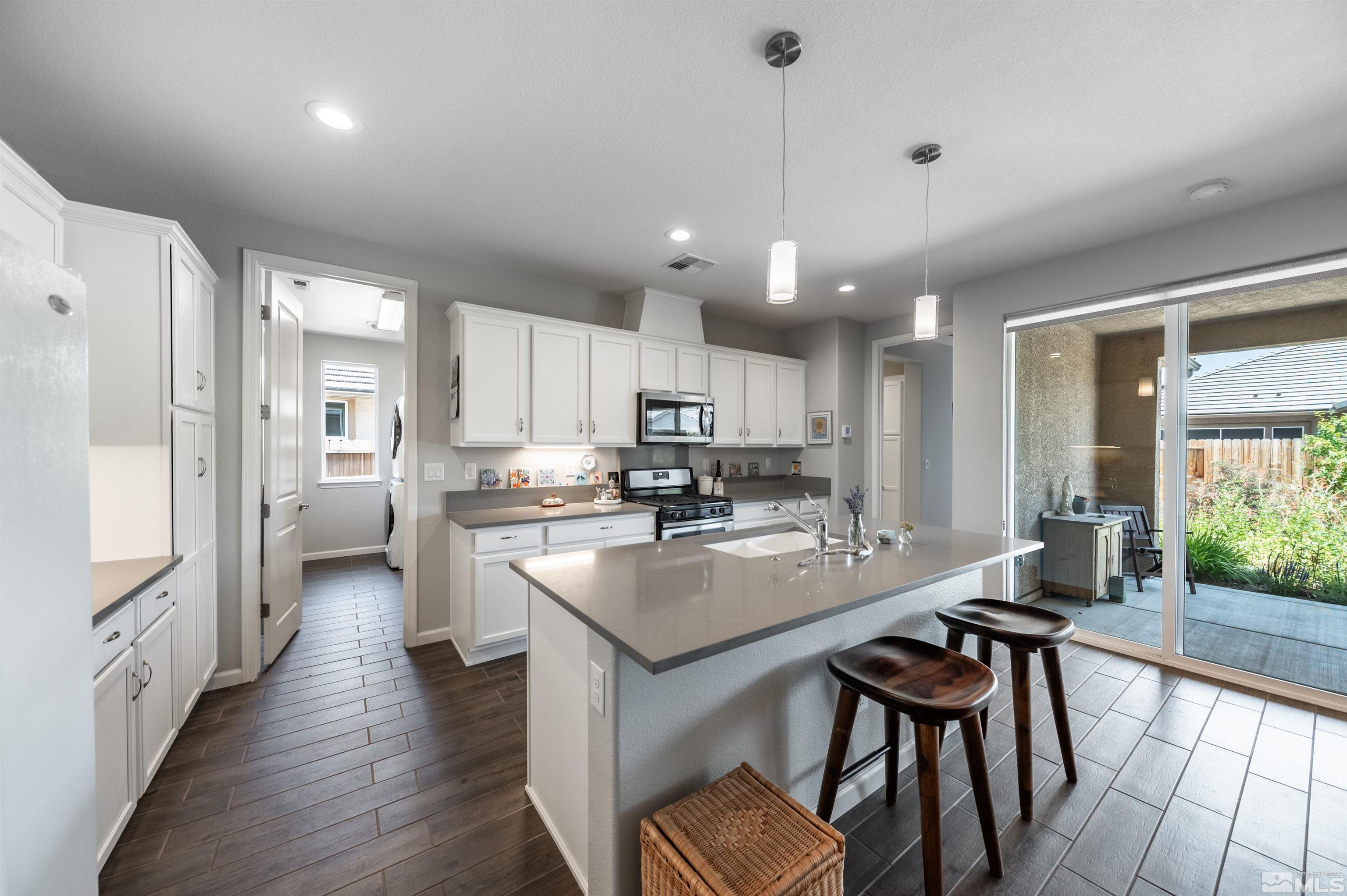 9566 Gazala Lane Reno, NV 89521 - Photo 8 of 40 a kitchen with stainless steel appliances granite countertop counter space a sink refrigerator and cabinets