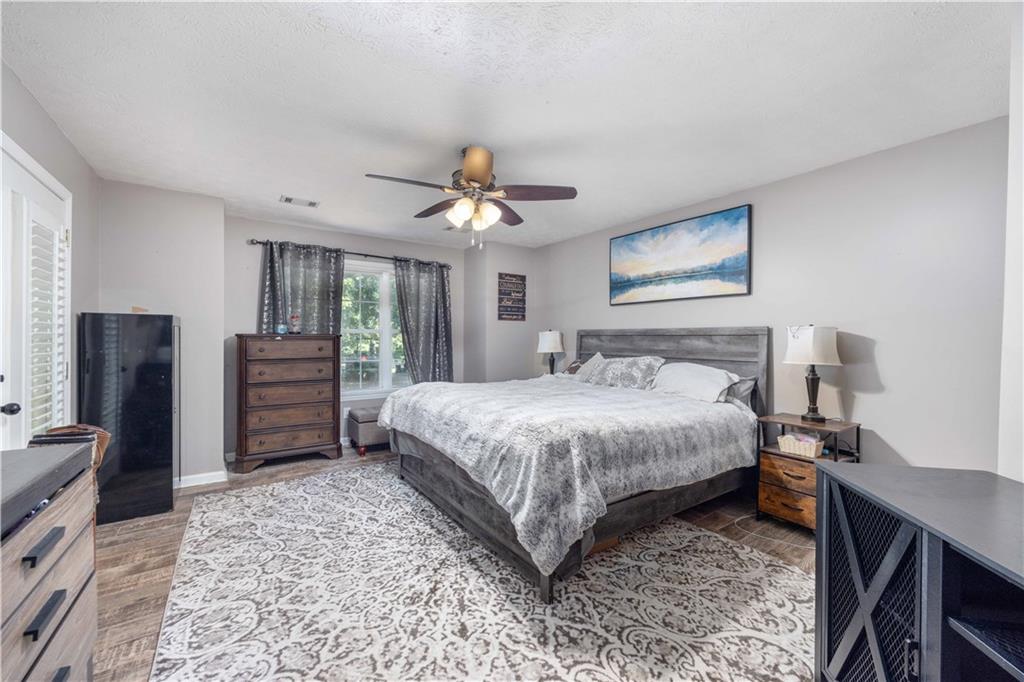 62 McCarthy Road Opelika, AL 36804 - Photo 22 of 74 Spacious room with wood-finish flooring, a ceiling fan, and a window providing natural light