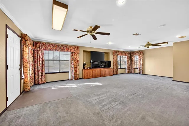 a view of a hallway with toilet and a refrigerator