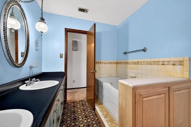 a bathroom with a sink and mirror