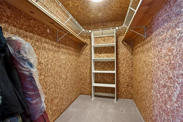 a view of a house with a big yard and large tree