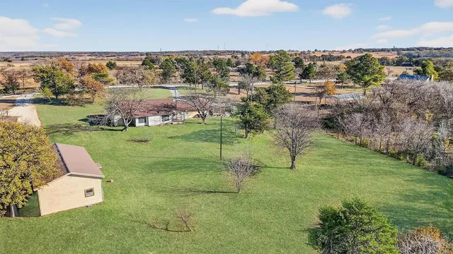 a view of a house with a yard and a garden