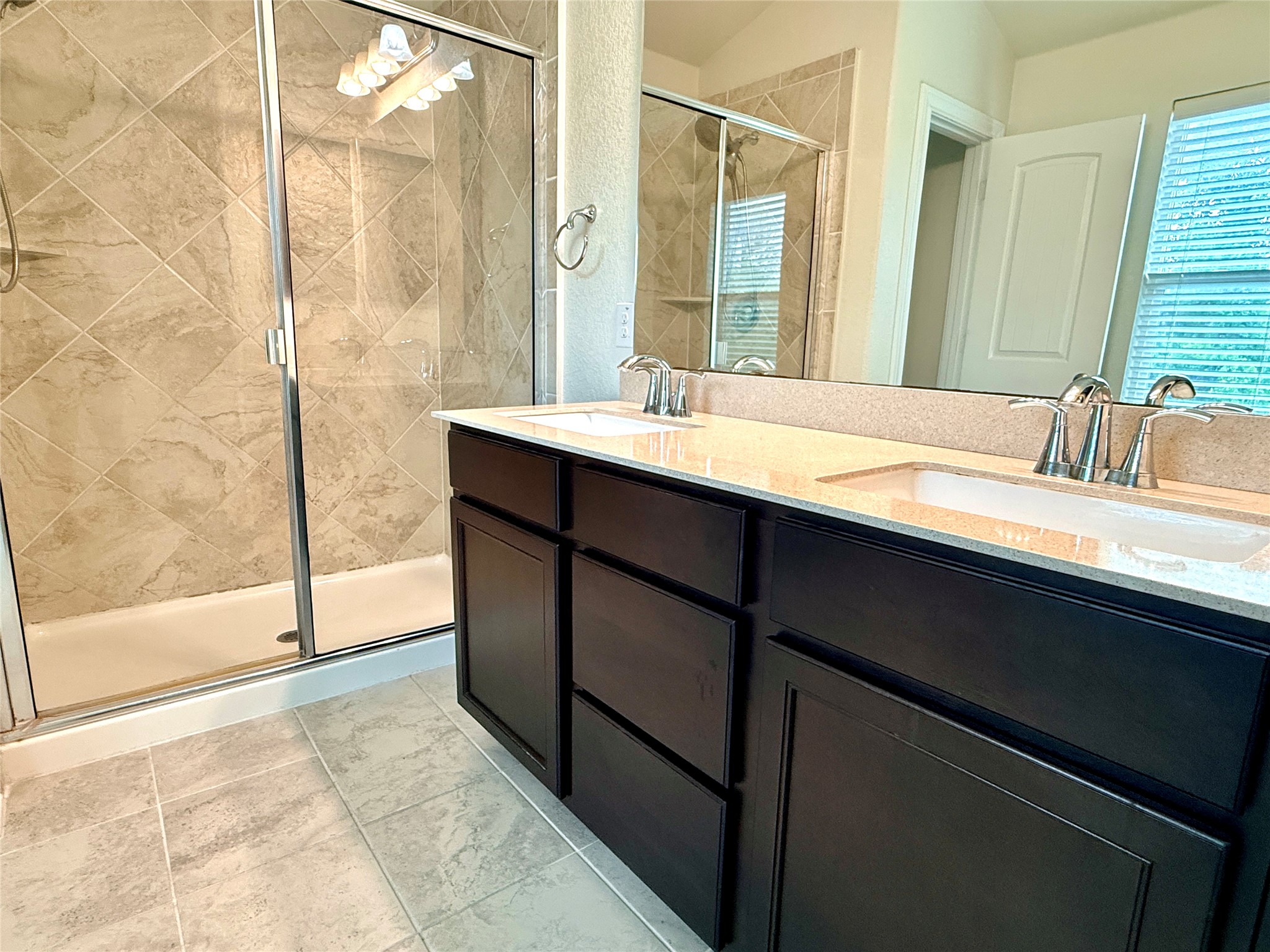 2101 Split Diamond Way, Unit 40 Round Rock, TX 78664 - Photo 24 of 32 Dual vanities with stone counters provide ample space in this well-appointed bath.