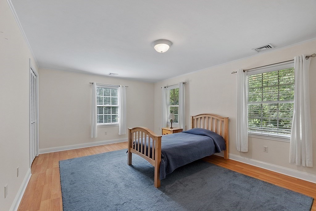 76 Wheeler Road Stow, MA 01775 - Photo 19 of 31 a spacious bedroom with a bed and a window