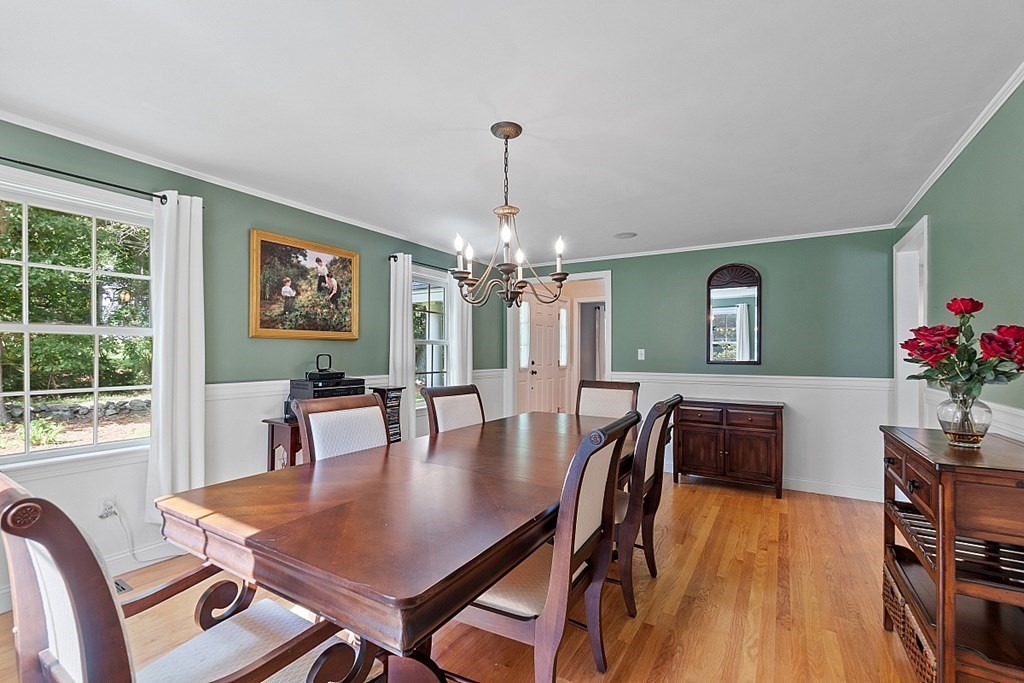 76 Wheeler Road Stow, MA 01775 - Photo 4 of 31 a dining room with furniture a chandelier and wooden floor