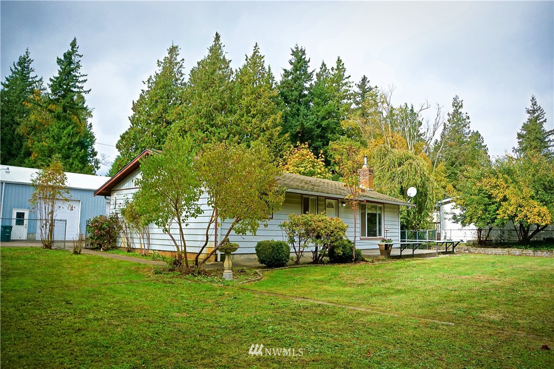 1746 Trigg Road Ferndale, WA 98248 - Photo 1 of 28 a front view of a house with a garden