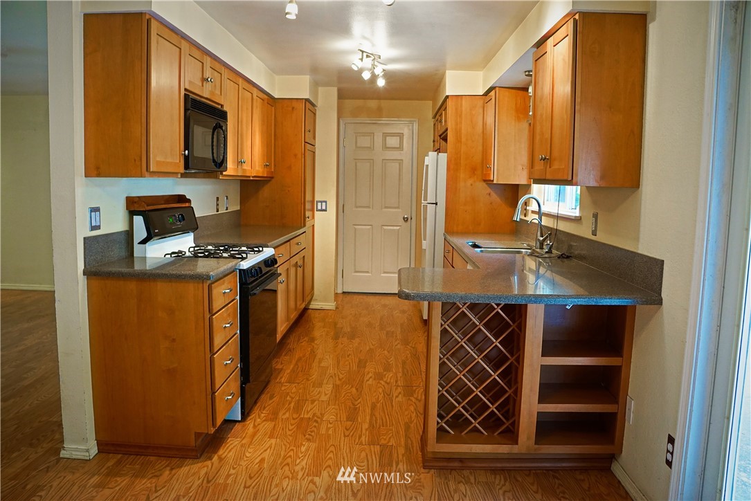 1746 Trigg Road Ferndale, WA 98248 - Photo 7 of 28 a kitchen with stainless steel appliances granite countertop a stove and a refrigerator