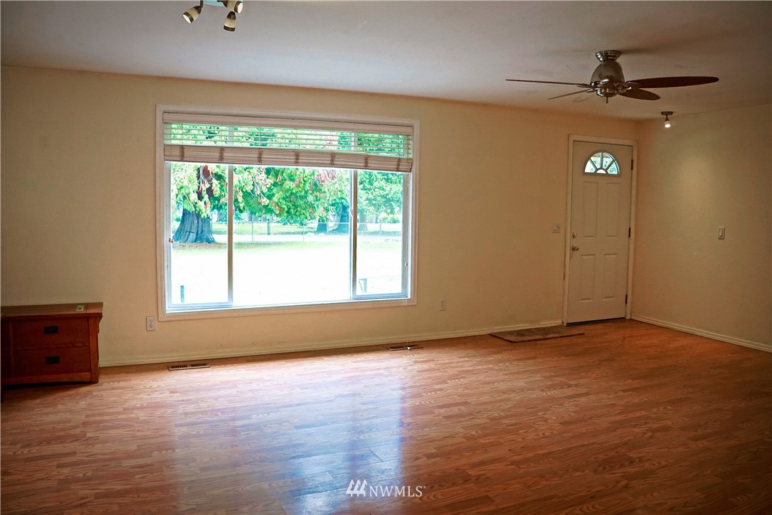 1746 Trigg Road Ferndale, WA 98248 - Photo 10 of 28 a view of an empty room with a window and wooden floor