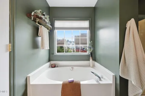 a bathroom with a granite countertop sink a toilet and mirror