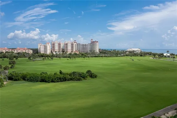 a front view of a building with lake view and tall buildings