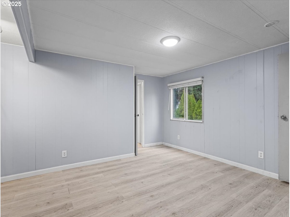 6610 Northwest Whitney Road, Unit 138 Vancouver, WA 98665 - Photo 18 of 34 a view of an empty room with wooden floor and a window