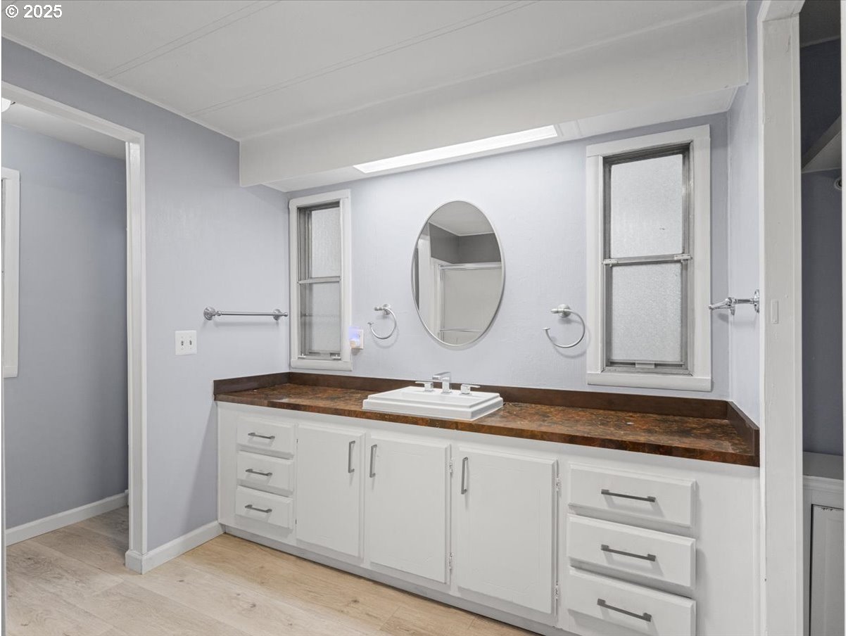 6610 Northwest Whitney Road, Unit 138 Vancouver, WA 98665 - Photo 19 of 34 a bathroom with a granite countertop sink mirror and vanity