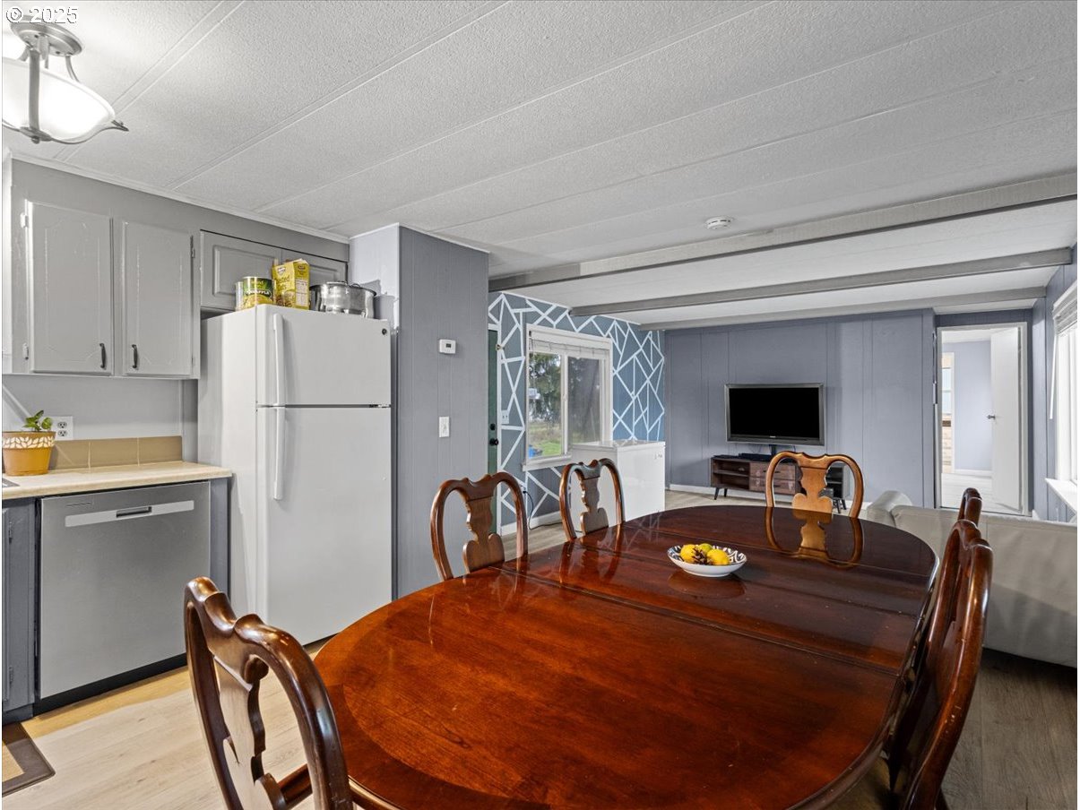 6610 Northwest Whitney Road, Unit 138 Vancouver, WA 98665 - Photo 8 of 34 a dining room with furniture and a refrigerator