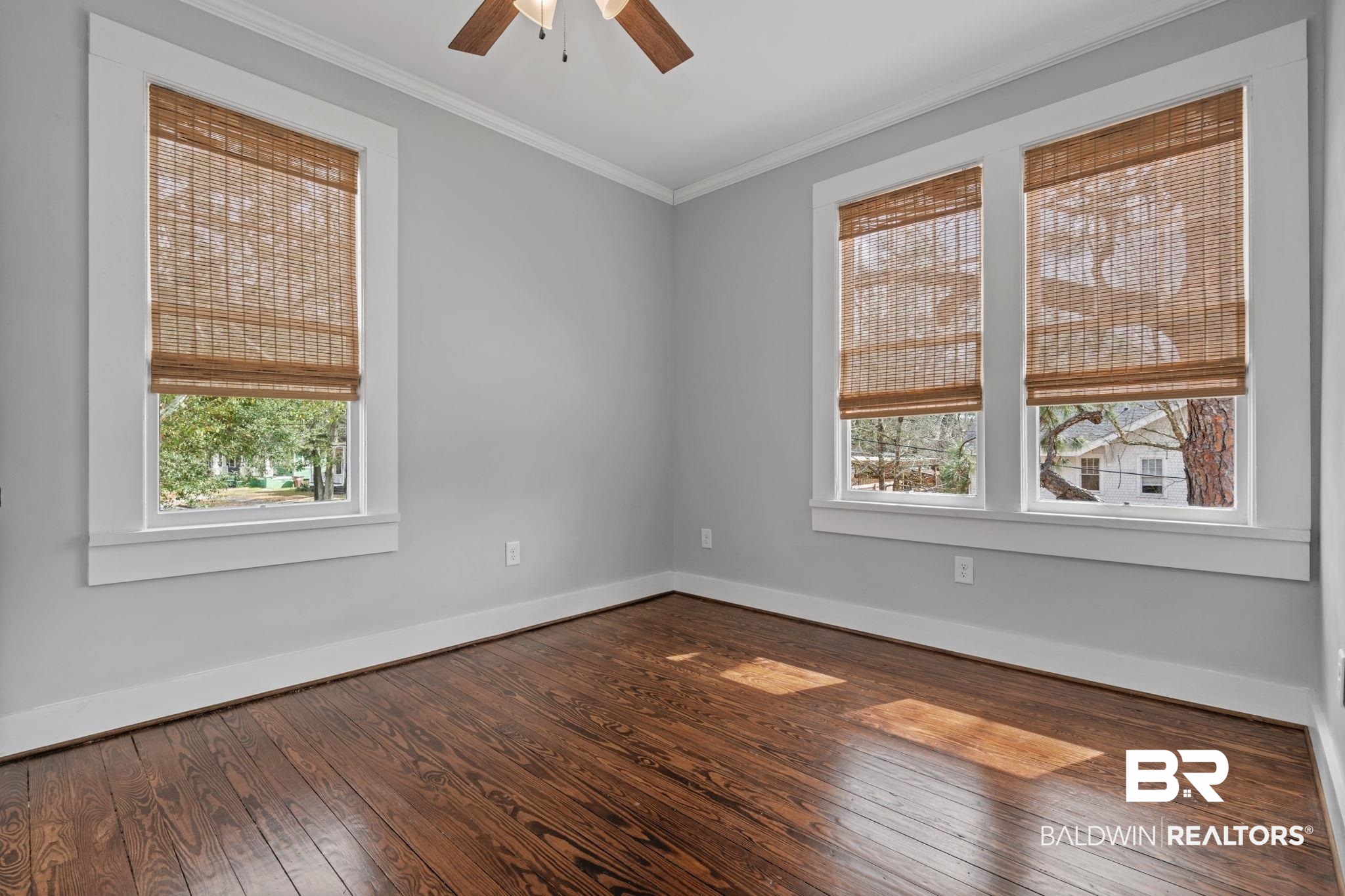 123 Macy Place Mobile, AL 36604 - Photo 18 of 35 Spare room featuring dark wood-type flooring, ceiling fan, crown molding, and healthy amount of natural light