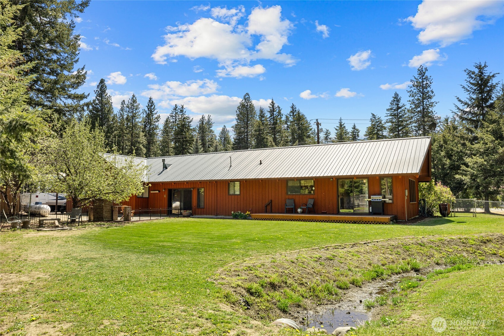 61 Lake Cabins Road Ronald, WA 98940 - Photo 27 of 29 a view of a house with a big yard and large trees